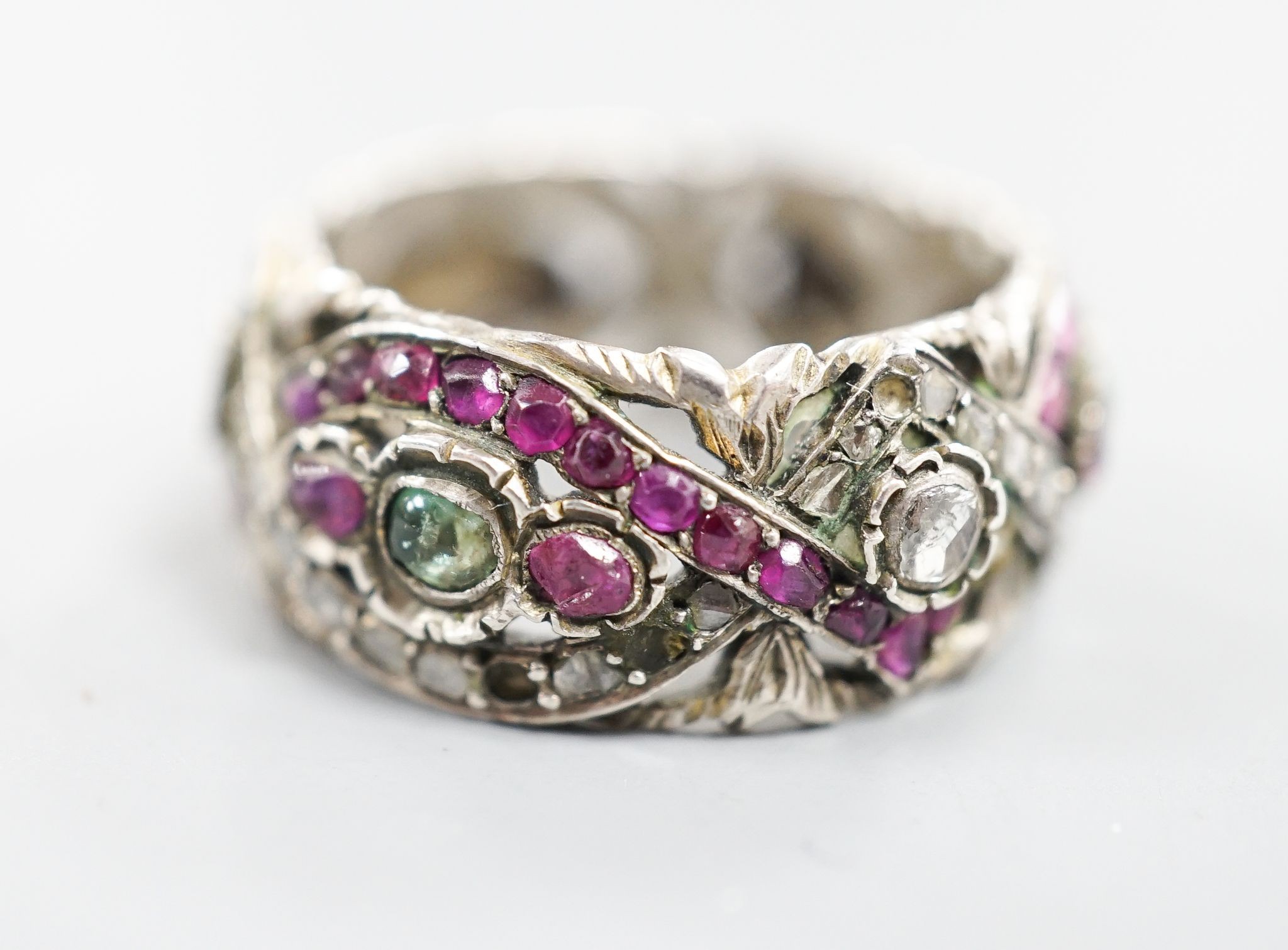A 19th century Austro-Hungarian pierced white metal, diamond and gem set band, size W/X.
